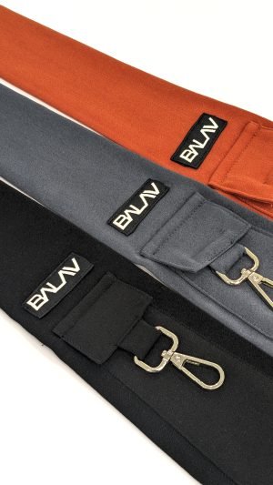 Three pocket ties in orange, gray, and black are aligned side by side.